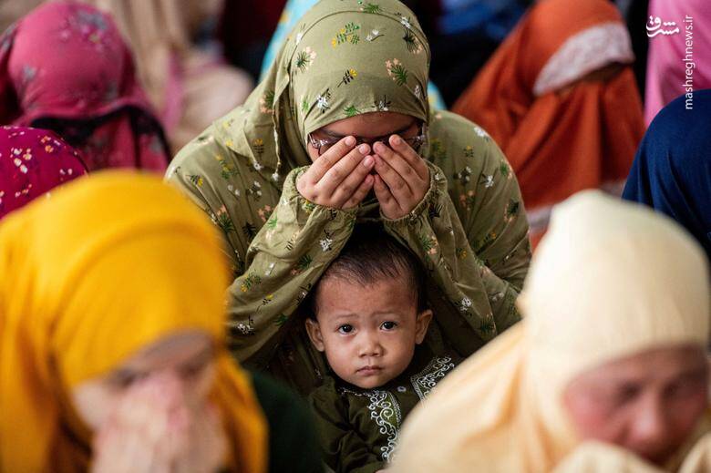 حضور یک کودک مسلمان با مادرش در نماز عید قربان در مانیل _ فیلیپین