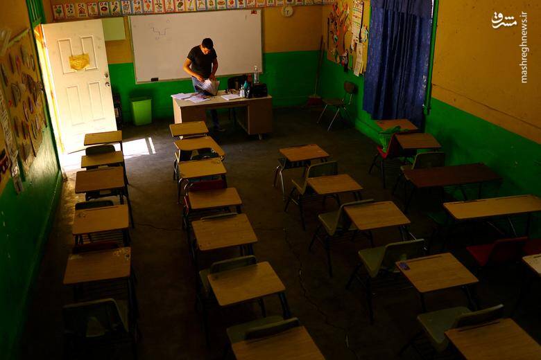 معلمی در حال آماده‌سازی مقدمات تدریس قبل از ورود دانش‌آموزان به کلاس در سیوداد خوارز _ مکزیک