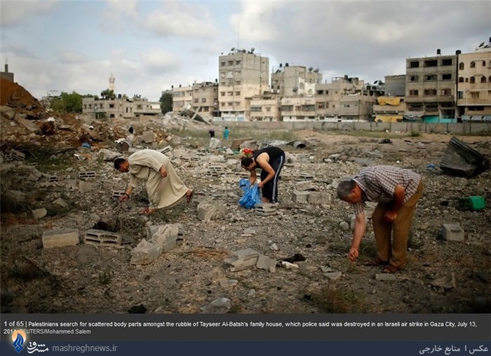 عکس/ جستجو برای یافتن تکه‌های بدن یک خانواده در غزه